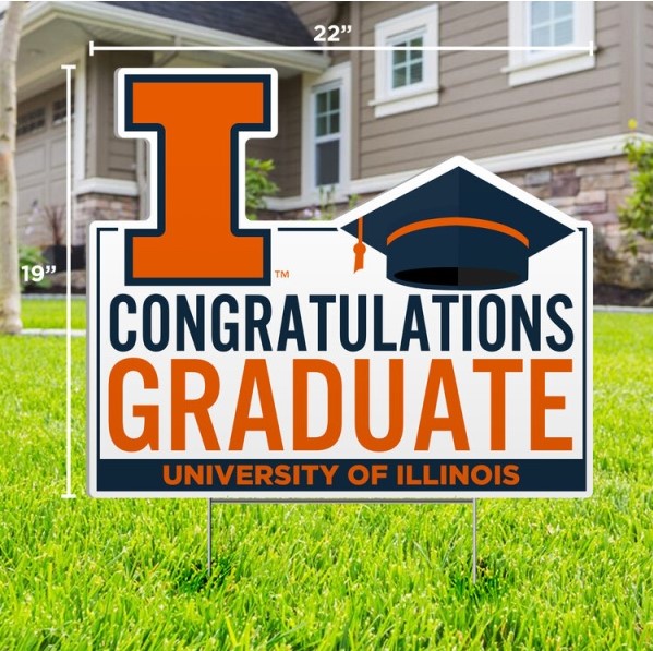 A yard sign reading "Congratulations Graduate" with the University of Illinois logo and a graduation cap, displayed on a lawn.